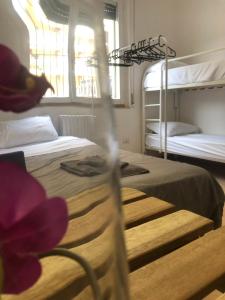 a bedroom with two bunk beds and a flower at Doberdó in Milan