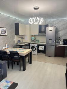 a kitchen with a table and a dining room at Менада Хоризонт Апартаменти in Sozopol
