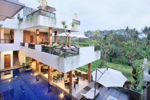 an aerial view of a building with a pool and trees at Puri Padma Hotel in Ubud