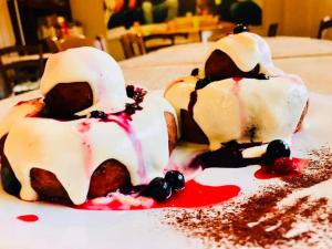 two cakes sitting on top of a table at Pensiunea Galileo in Borşa