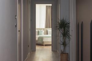 a bedroom with a bed and a potted plant at Sea Star Budva in Budva