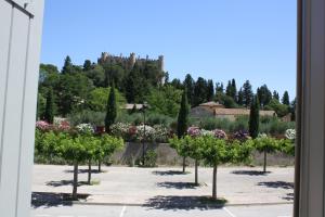 a row of trees with a castle in the background at La Remiso in Montfaucon