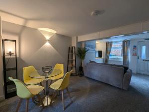 a living room with a table and chairs and a couch at BotolphsView Terrace Boston in Lincolnshire
