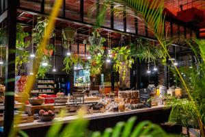 a restaurant with plants in the foreground at Hotel Indigo Brussels - City by IHG in Brussels