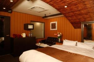 Postelja oz. postelje v sobi nastanitve HOTEL K's ABA Adult Only