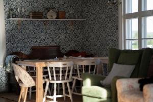 a living room with a wooden table and chairs at Älvstugan in Övertorneå