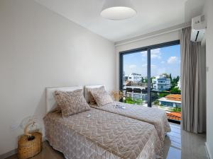 a bedroom with a bed and a large window at Starlight Terrace PENTHOUSE in Marmara