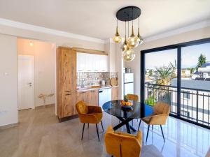 a kitchen and dining room with a table and chairs at Starlight Terrace PENTHOUSE in Marmara +4 photos