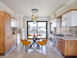 a kitchen with a table and chairs and a dining room at Starlight Terrace PENTHOUSE in Marmara