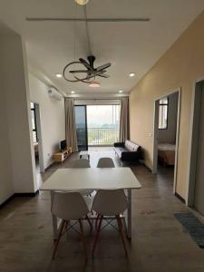 a living room with a white table and chairs at Fify Homestay in Putrajaya
