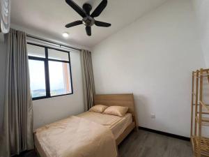 a bedroom with a bed and a ceiling fan at Fify Homestay in Putrajaya