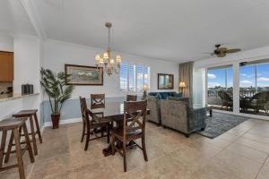 a dining room and living room with a table and chairs at Vanderbilt Beach Resort in Naples