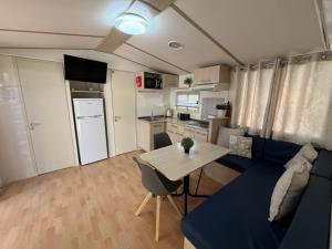 a living room with a blue couch and a table at Mobile Fontana Oasis in Castelnuovo del Garda +84 photos