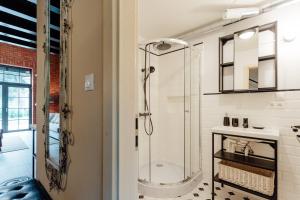 a bathroom with a shower with a glass shower at Fajnové apartmány in Vyhne