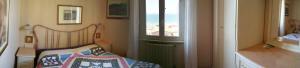 a small room with a bed and a window at Residence Il Sole in Follonica