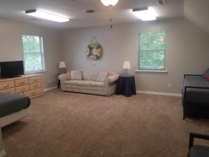 a living room with a couch and a tv at Makin MEMORIES: with Dock/Hot Tub/Cable Internet in Bremen