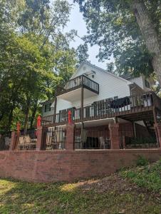 a house with a deck on a brick wall at Makin MEMORIES: with Dock/Hot Tub/Cable Internet in Bremen