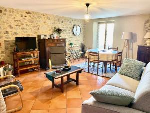 a living room with a couch and a table at Anthémis I, II, III in Les Angles