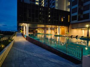 a swimming pool in a building at night at BaliResidenc Sea View 2-6 Pax WaterPark 5minJonker in Melaka