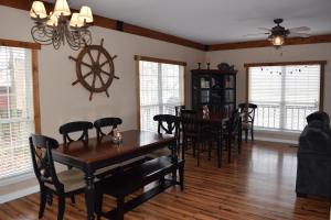 a dining room with a wooden table and chairs at Makin MEMORIES: with Dock/Hot Tub/Cable Internet in Bremen