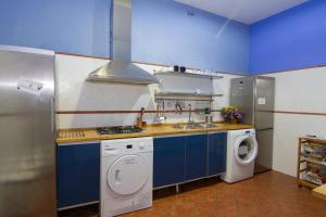 a kitchen with a sink and a washing machine at Villa Alicia Guest House in Málaga +53 photos