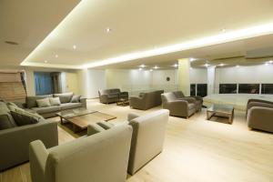 a large living room with couches and a bed at Lindos Royal Resort in Líndos