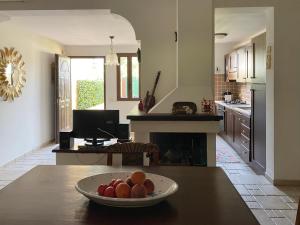 a kitchen with a bowl of fruit on a table at Casa Robi in Flumini di Quartu