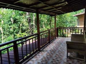 a porch of a house with a bench on it at Umah mimpi in Tampaksiring