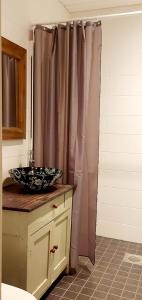 a bathroom with a sink and a shower curtain at Apartment Lintu in Mikkeli +14 photos