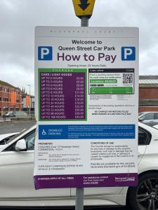 a parking sign in front of a car park at Luxury Apartment in Blackpool