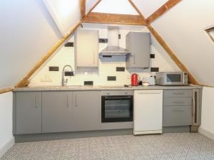 a kitchen in the apex of a roof at Apartment 4 Chameleon House in Harleston