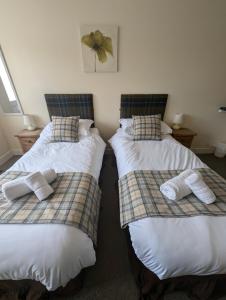 two beds sitting next to each other in a room at The Yew Tree at Longhope in Longhope