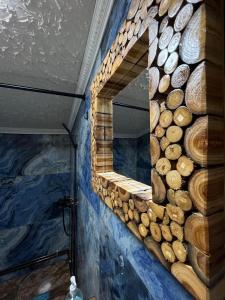 a wall with a mirror made out of logs at Cabana de sub Nuc in Ocna Şugatag +141 photos
