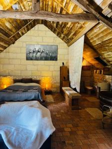a bedroom with a large bed in a attic at Château de la Thibaudière - Chambre des oiseaux in Allonnes +25 photos