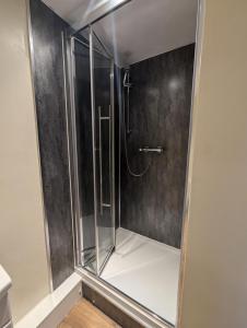 a shower with a glass enclosure in a bathroom at The Yew Tree at Longhope in Longhope +36 photos