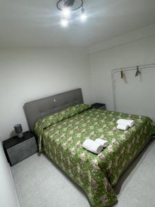 a bedroom with a bed with two towels on it at Da Riccardo in Fornelli