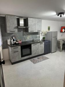 a kitchen with a sink and a refrigerator at Da Riccardo in Fornelli +38 photos