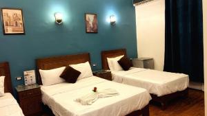 Voodi või voodid majutusasutuse Minerva Grand Hostel Cairo toas