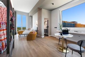 a bedroom with a bed and a large window at Vesuvius Palace Aparthotel in Ercolano