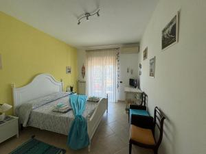 a bedroom with a bed and a table and chairs at La Dimora di Livia in Lido di Ostia
