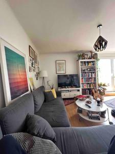 a living room with a couch and a table at Room in Rooftop Apartment in Vienna