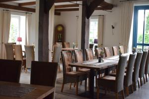a dining room with a wooden table and chairs at DZ/EZ Lodberger Scheunencafe in Löningen