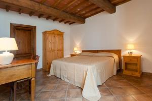 a bedroom with a bed and a table and lamps at Fattoria Javello - Agriturismo La Casaccia in Montemurlo +30 photos