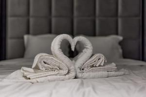 two towels are made to look like swans on a bed at Bounce Belgrade Apartment in Vračar (historical)
