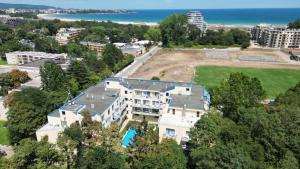 an aerial view of a building with the ocean in the background at Solei Apartments in Primorsko