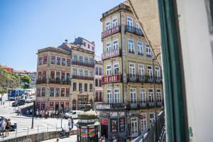 a view from a window of a street with buildings at Impar Studios in Porto
