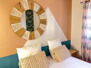 a bedroom with a mirror and a bed with pillows at Tropicalme Pamandzi in Pamandzi +72 photos