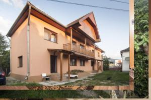 a house with a balcony on the side of it at Casa Finna in Covasna