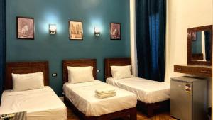 Voodi või voodid majutusasutuse Minerva Grand Hostel Cairo toas