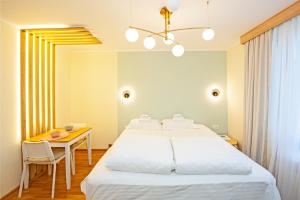 a bedroom with a large bed and a table at Cozy Lodge Kopaonik in Kopaonik